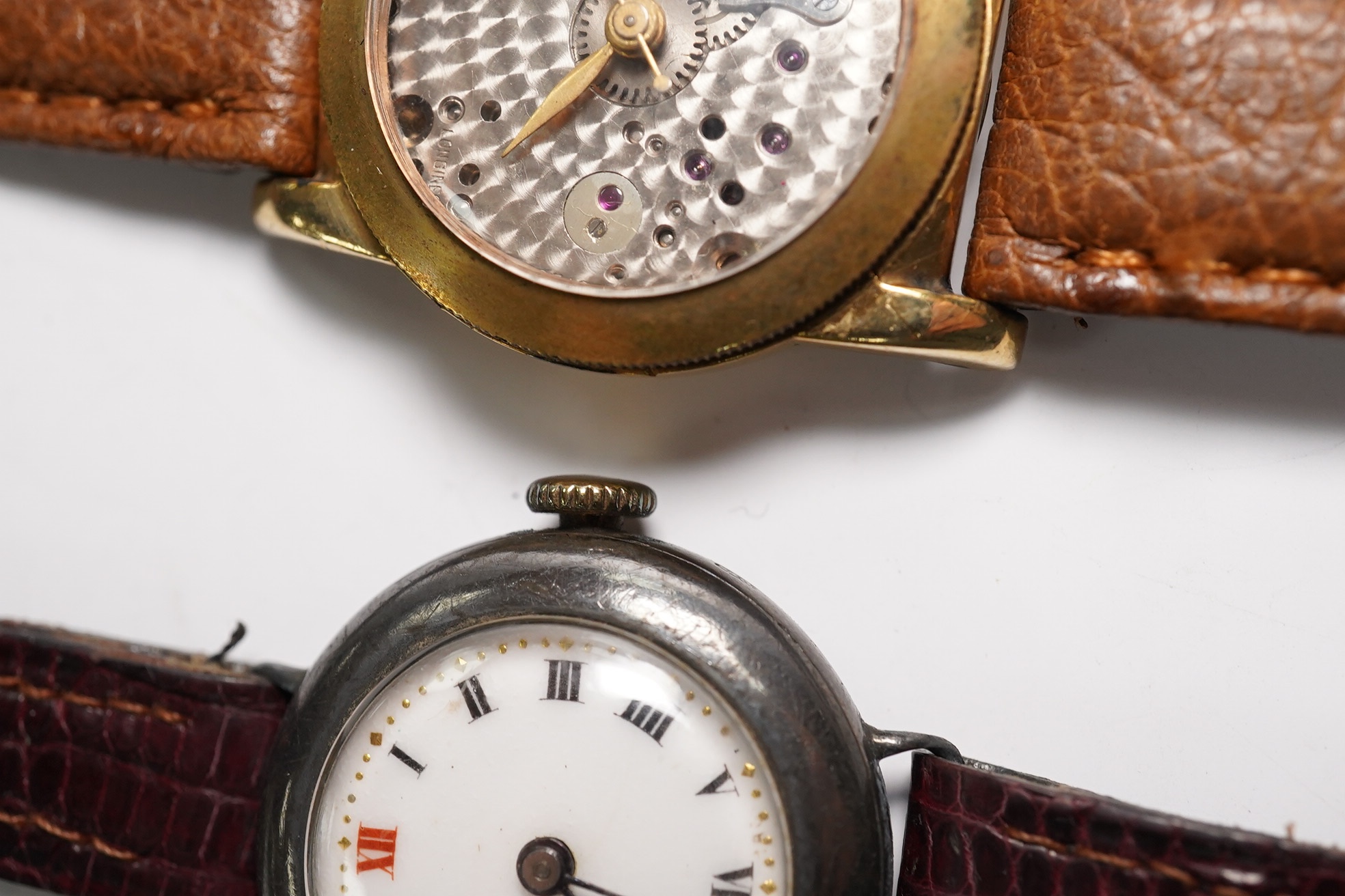 A gentleman's 1940's 10k gold filled Longines Weems? manual wind wrist watch, lacking dial, case diameter 28mm, together with a lady's silver wrist watch. Condition - poor to fair